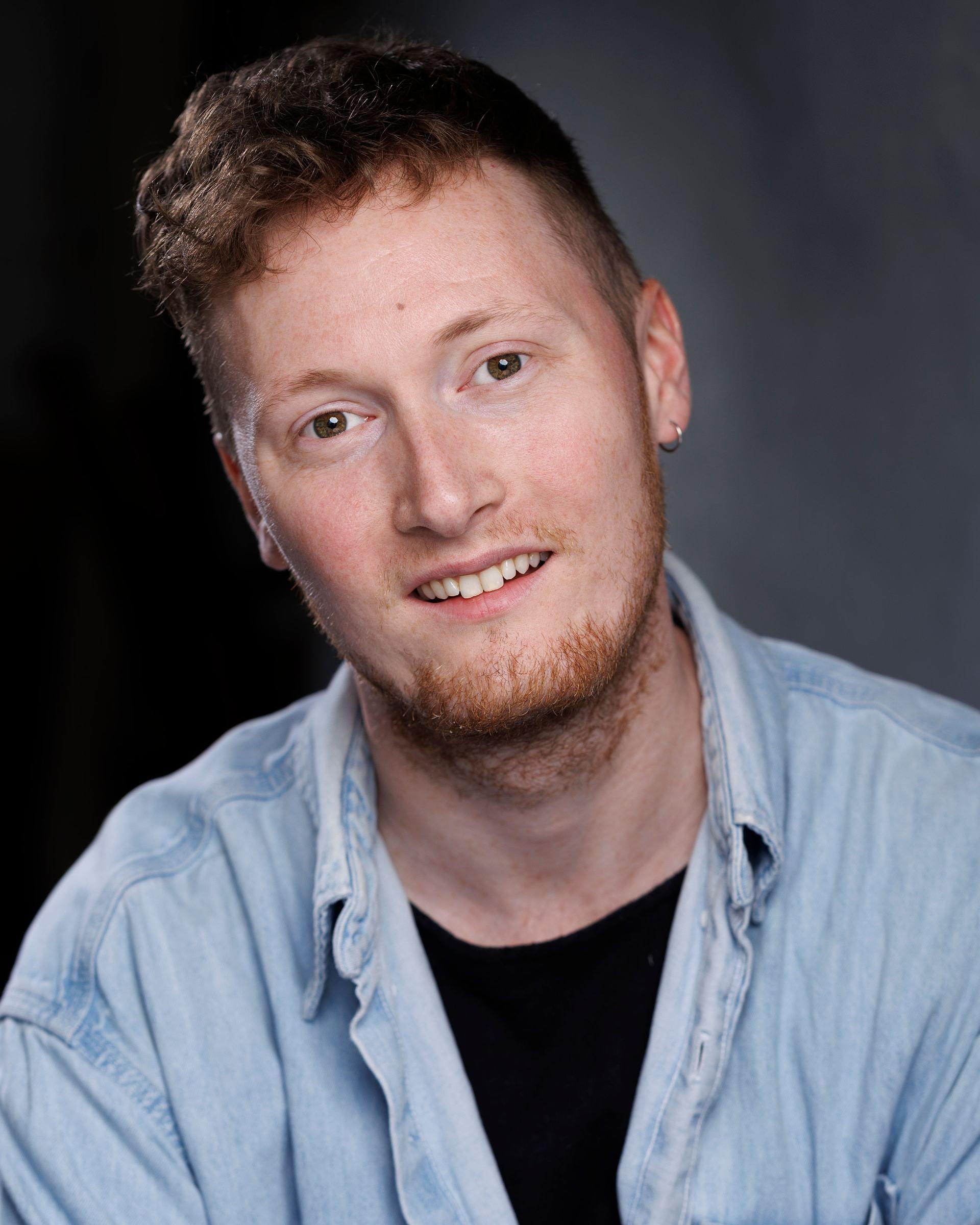 Seb Yates-Cridland headshot smiling denim shirt